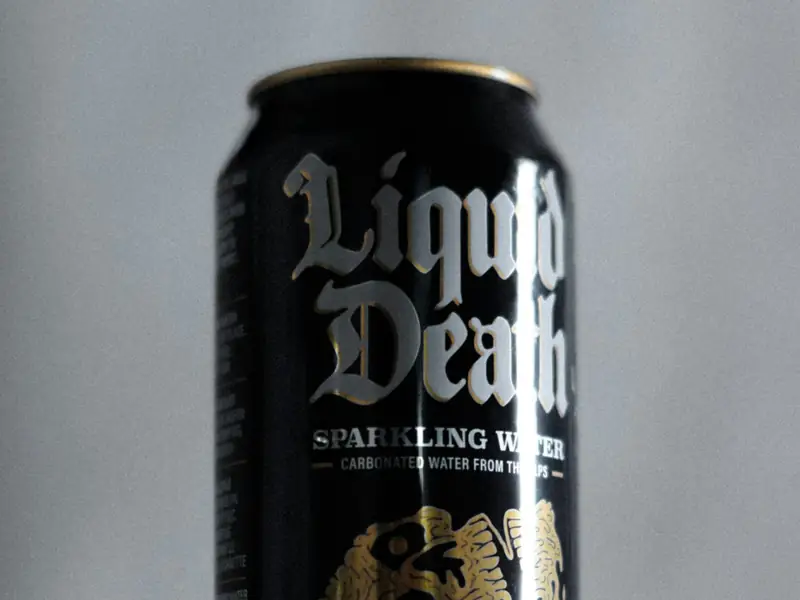 A black Liquid Death sparkling water can on a table